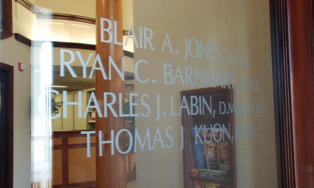 Glass front door etched with the doctors’ names