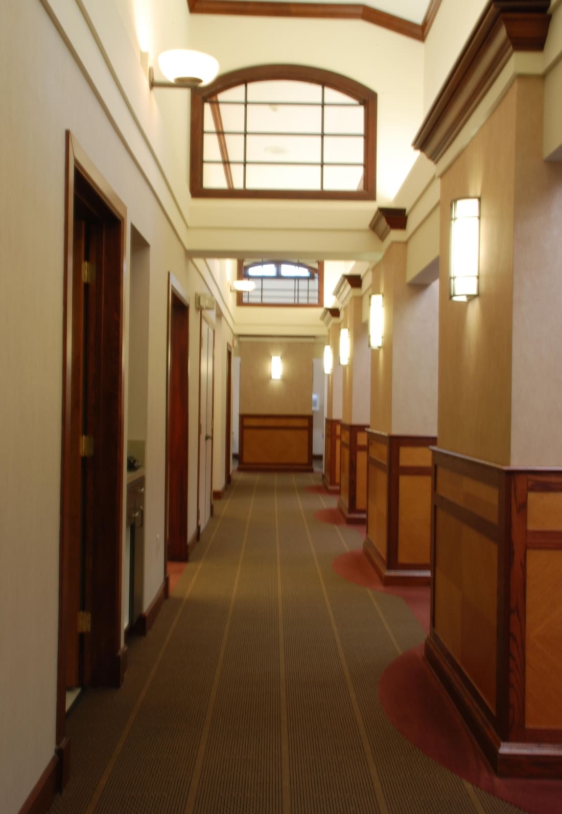 Warm wood-paneled hallway leading to treatment rooms
