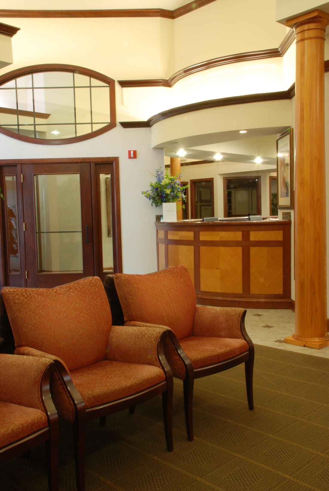 Welcoming reception area with wood paneling and fresh flowers