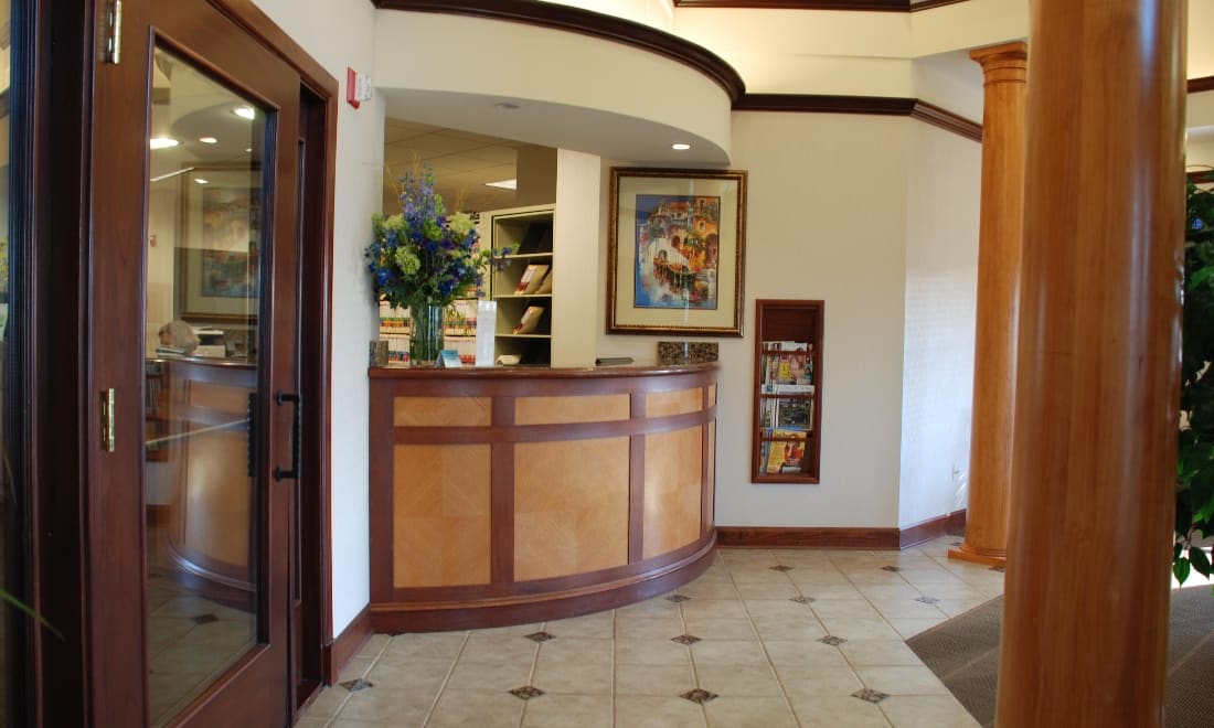 Bright reception desk with warm wood paneling